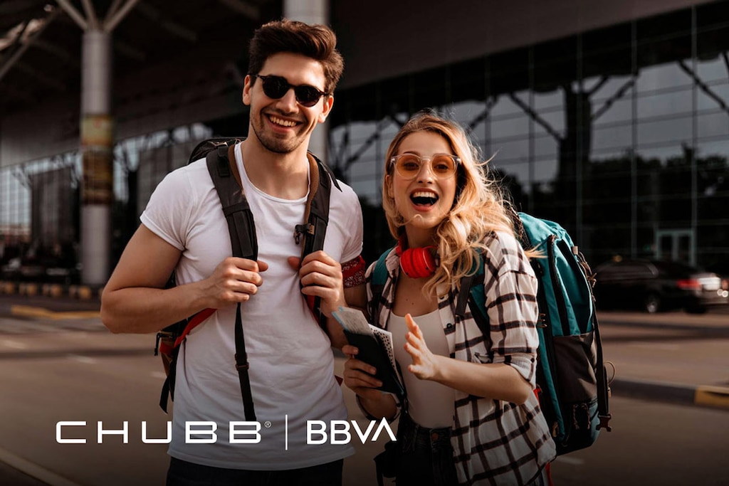 Junges Paar mit Rucksäcken am Flughafen; Logos von Chubb und BBVA zur Reiseversicherung.