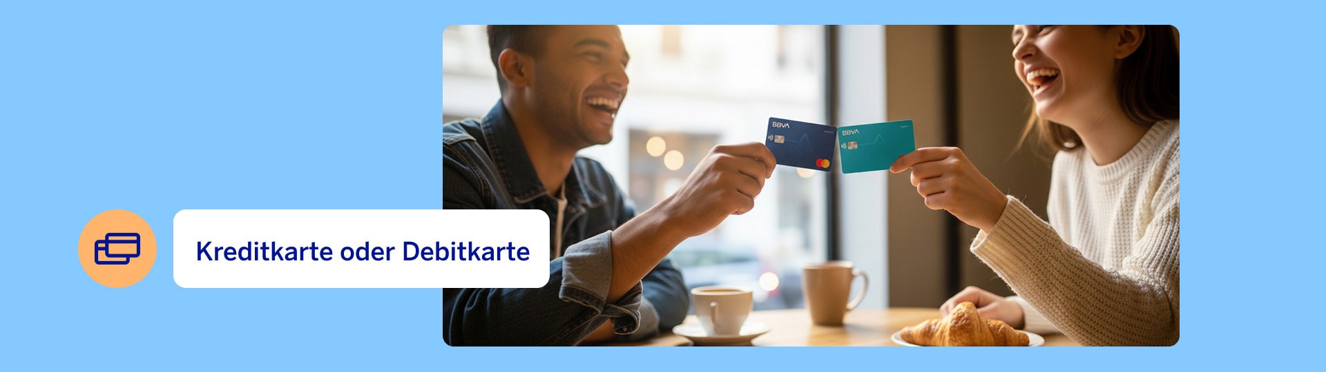 Two people sitting at the table, laughing and holding their credit and debit cards in their hands.