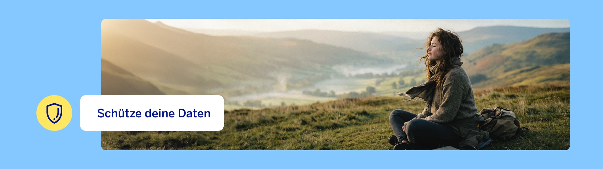 A person is sitting relaxed in a wide hilly landscape – a symbolic image for mindfulness and digital self-care on Change-your-password Day.
