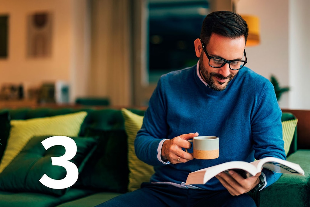 Man reading travel insurance contract documents; payment is made directly via the current account in the App.